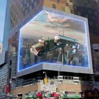 Sony Man Clings to Rope Beside Floating Truck