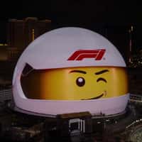 LEGO Emmet Drives F1 Cars Across Sphere