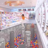 DM Woman Jumping on Lipsticks Above Ball Pit