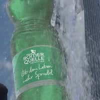 Römerquelle Emerges in Waterfalls at a Building