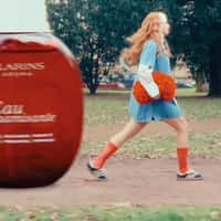 Clarins Woman Playing with Beauty Products
