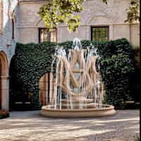 AMIRI Golden Logo Fountain in Garden