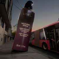 L'BEL Bottle Pours Serum on Bus