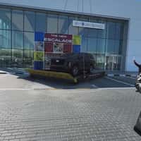 Cadillac Helicopter Transports Car Outside Showroom