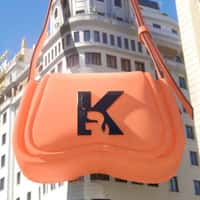 Karl Lagerfeld Orange Bag Hangs on the Building