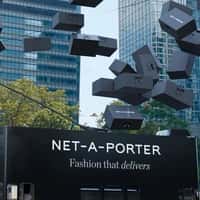NET-A-PORTER Double-decker Bus Unloads Black Boxes
