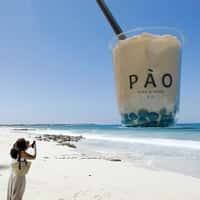 PÀO Two Giant Bubble Teas Tower Over Beach