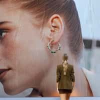 Reis Woman Takes Giant Earring From Billboard
