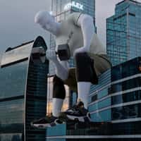 Sportmaster Giant Man Lifting Dumbbells on Building