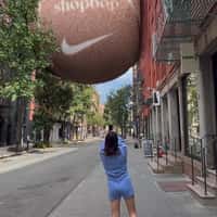 ShopBop Tennis Ball Stuck Between Buildings
