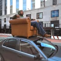 House of Pezzo Man on Couch on Car Roof
