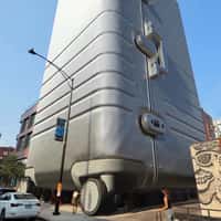 Monos Giant Suitcase Reveal Building
