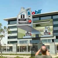 Mobil Building Facade Opens for Giant Oil Bottles