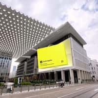 Gold Apple Giant Bag Emerges from Facade