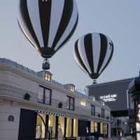 AMI Black and White Hot Air Balloons Float Above Cafe