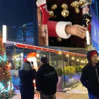 Saber Energy Santa's Hand with Can Pops Out of Billboard