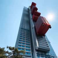 Samsonite Red Luggage on Skyscraper Conveyor Belt