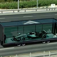 Adidas Race Car Rides Car Carrier on Highway