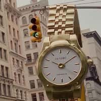 Cendré Watch Hanging Over Traffic Light on Street
