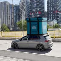 Alula Eating House Giant Wolt Box Atop Car