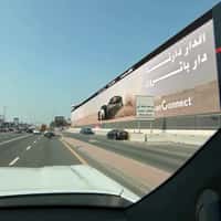 Nissan Cars Kick Up Sand From Billboard