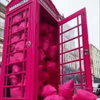 Garage Telephone Booth Overflows with Tote Bags