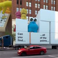 Board Giant Arms Play Puzzle Blocks on Facade