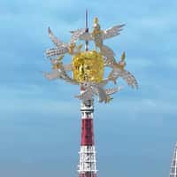 Birds Carrying Yellow Diamond Above Tower