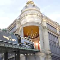 Printemps Steam Train Driving Through Buildings