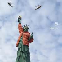Grubhub Statue of Liberty Wears Orange Jacket