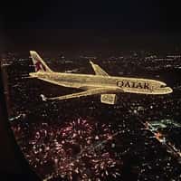 Qatar Airways Plane Flying Over Fireworks