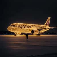 Qatar Airways Plane Adorned with Lights on Tarmac