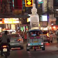 The Ordinary Bottle Rides Tuk Tuk in Thailand
