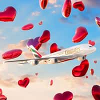 Emirates Plane Flies with Floating Heart Balloons