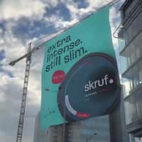 Skruf Poster Rolls Down From a Crane