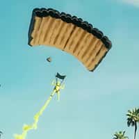 TRUFF Green Figure Releasing Smoke on Parachute