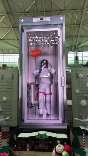 Astronaut Leaps for Flying Ticket in Elevator in a 3D Billboard ad of Unknown