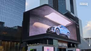 Car Moves in Changing Backgrounds in a 3D Billboard Ad of Audi