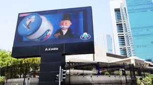 Mr. Monopoly Spins Out Cream Cheese Bottle in a 3D Billboard ad of Puck