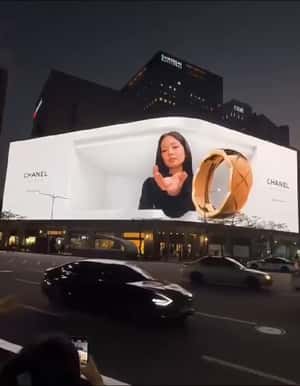 Gold Ring Emerges from Screen in a 3D Billboard ad of Chanel