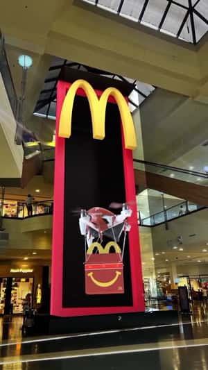 Drone Carries Happy Meal Box in a 3D Billboard Ad of McDonald's
