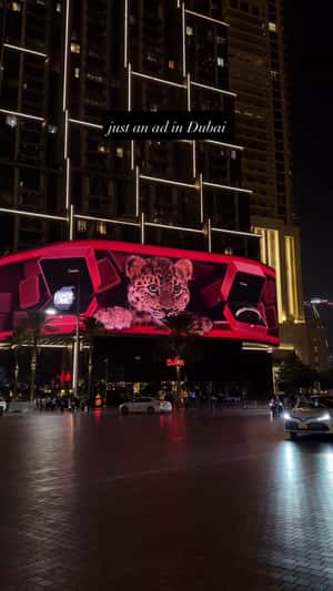 Baby Panther Looks Out from Red Boxes in a 3D Billboard ad of Cartier 