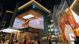 Golden Bull Breaks Through Glass Screen in a 3D Billboard ad of Unknown