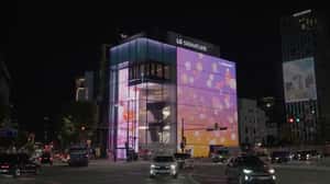 Orange Ball Floats Through Petals and Clouds in a 3D Billboard ad of LG