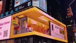 Astronaut Brings Cup Outside the Screen in a 3D Billboard ad of LEGO