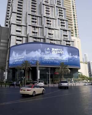 Waves Slam Over Submerged Bottles in a 3D Billboard ad of Adidas