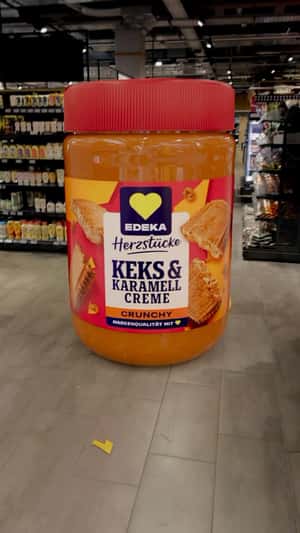 Giant Caramel Crème Appears at Supermarket in a fake-out-of-home promotional ad of EDEKA