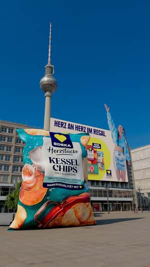 Chip Tossed from Billboard in a fake-out-of-home ad of EDEKA