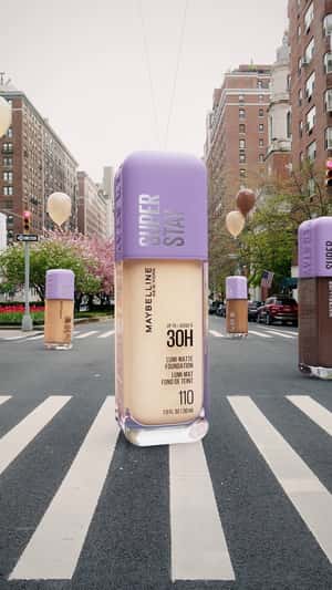 Foundation Carried by Balloons in a fake-out-of-home ad of Maybelline