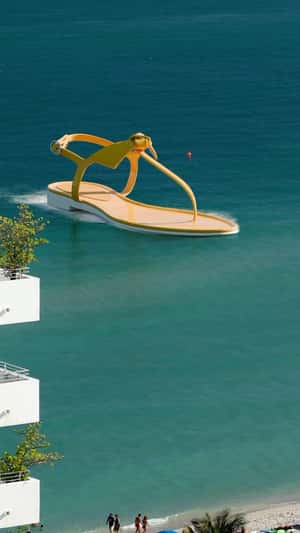Sandal Cruises Over the Beach in a fake-out-of-home ad of Alexandre Birman
